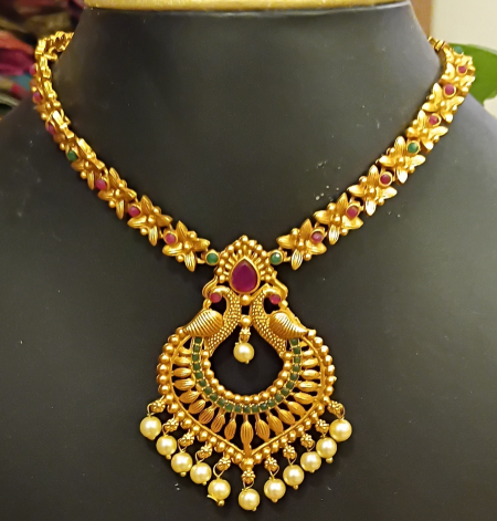 Gold necklace with ruby and emerald 